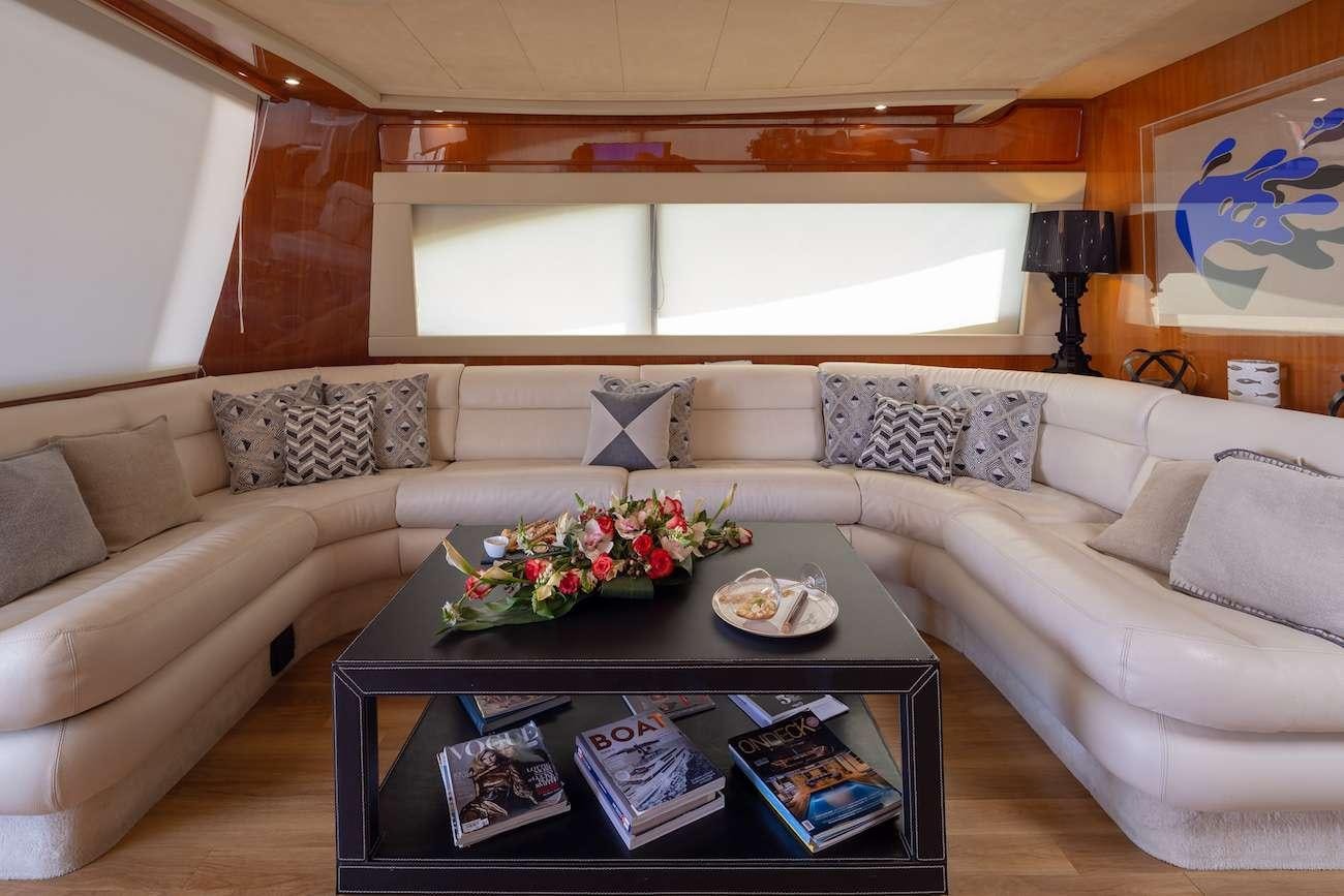 a living room with a couch and coffee table aboard AMOR Yacht for Charter