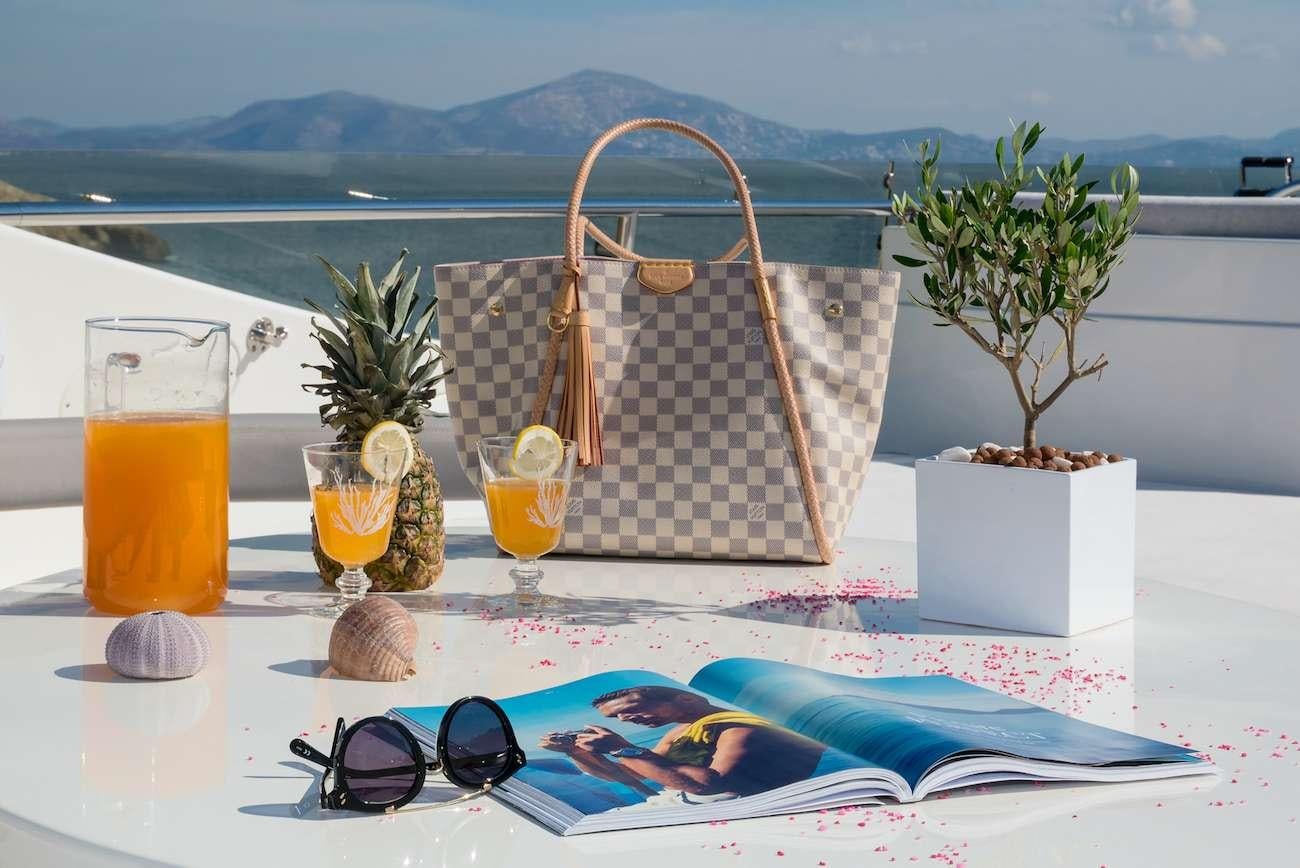 a table with a basket and sunglasses aboard AMOR Yacht for Charter