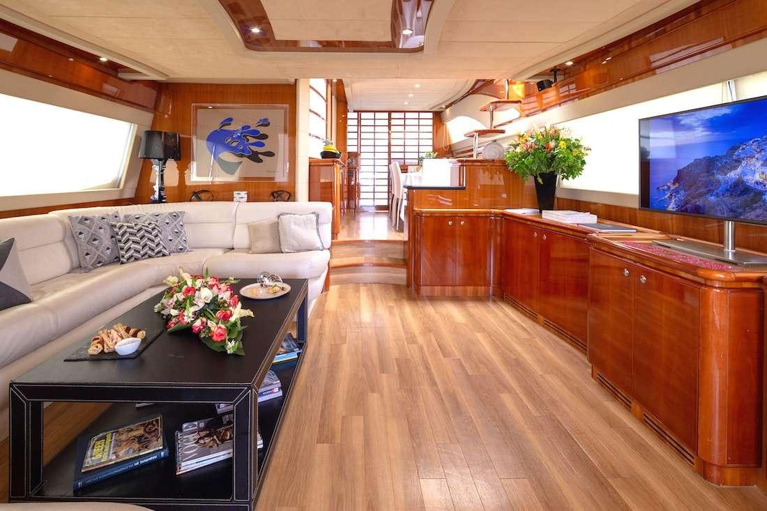 a living room with a large sofa aboard AMOR Yacht for Charter