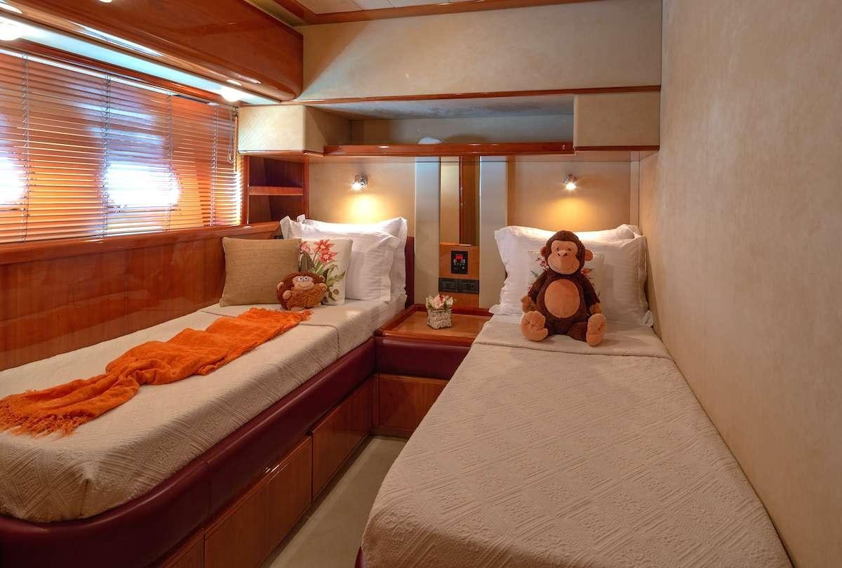 a hotel room with a bed and teddy bear aboard AMOR Yacht for Charter
