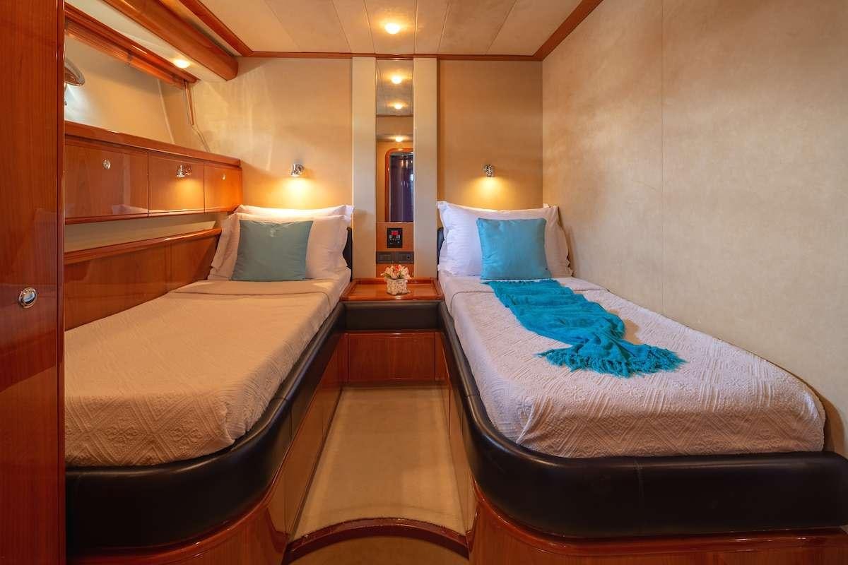 a room with two beds aboard AMOR Yacht for Charter