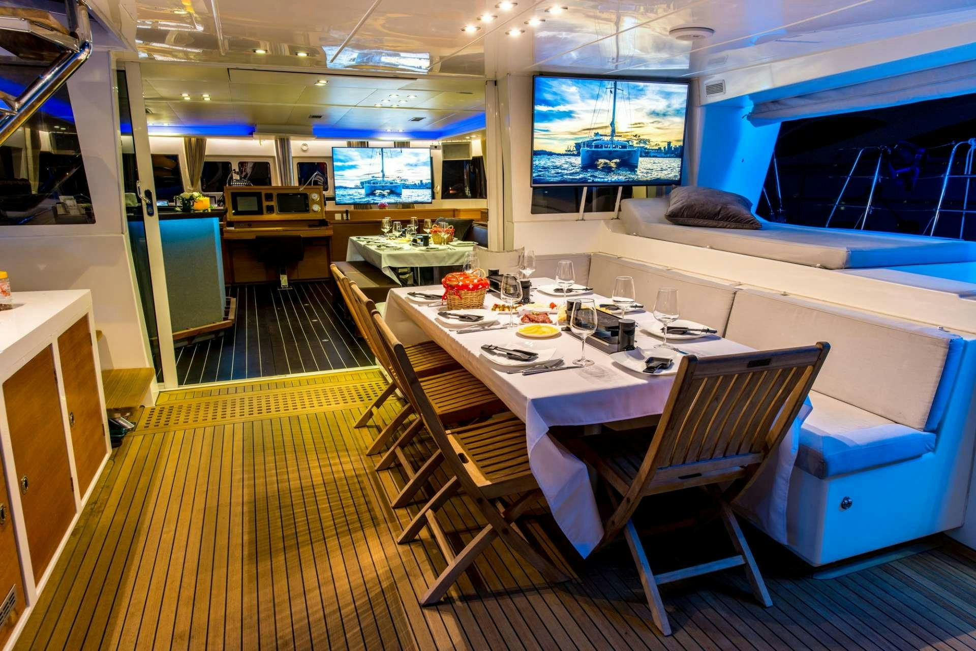 a room with a table and chairs aboard PRIMETIME Yacht for Charter