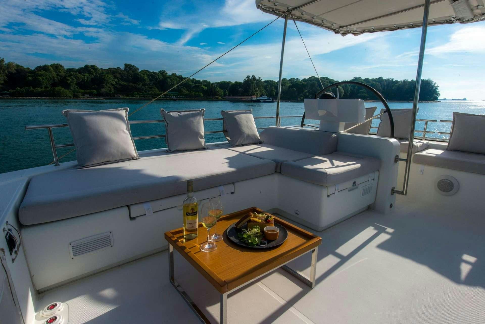 a boat with a table and chairs aboard PRIMETIME Yacht for Charter