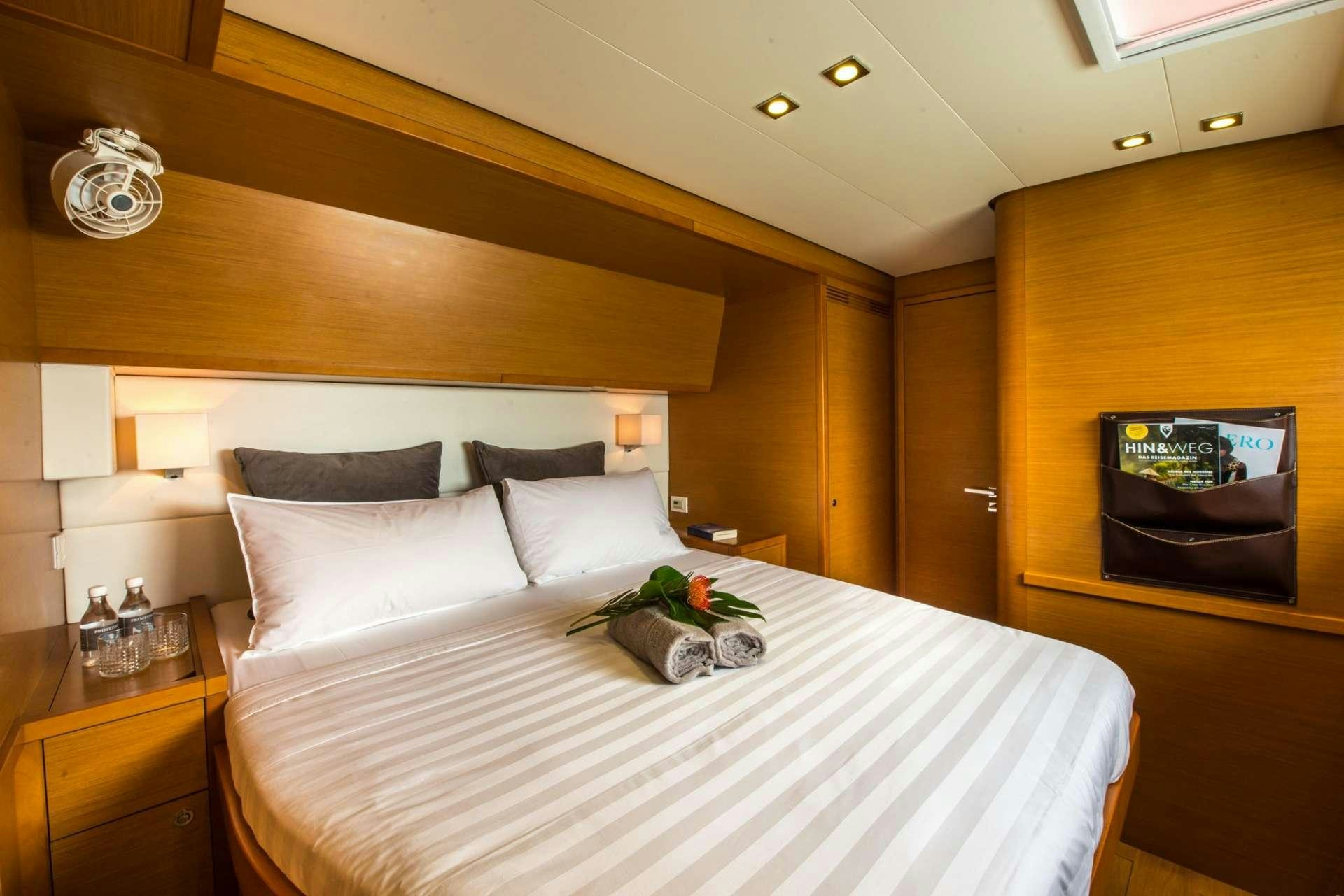 a bed with white sheets and pillows aboard PRIMETIME Yacht for Charter