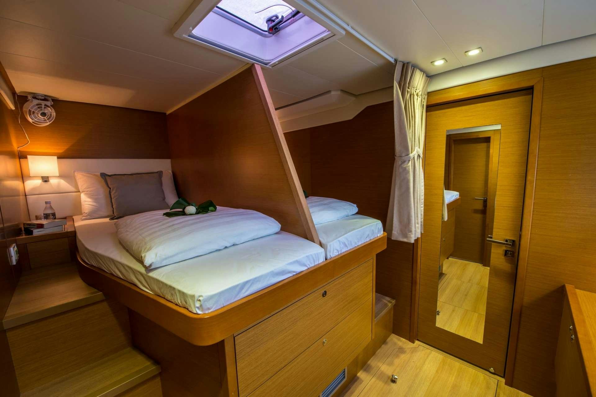a room with a bed and a door aboard PRIMETIME Yacht for Charter