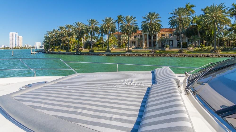 a swimming pool with palm trees and buildings in the background aboard ALL GOOD Yacht for Charter
