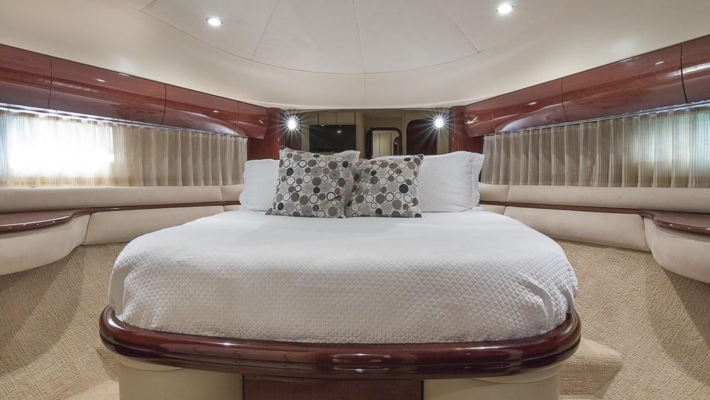 a bed with white sheets aboard ALL GOOD Yacht for Charter