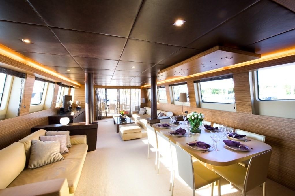 a room with a table and chairs aboard GIOE I Yacht for Charter