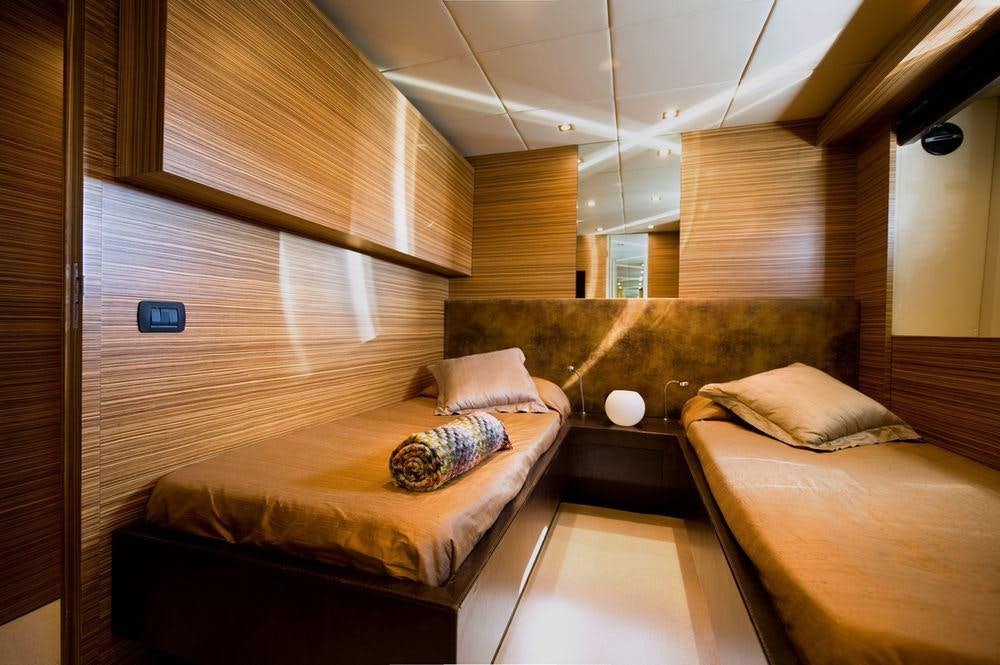 a room with a bed and a couch aboard GIOE I Yacht for Charter