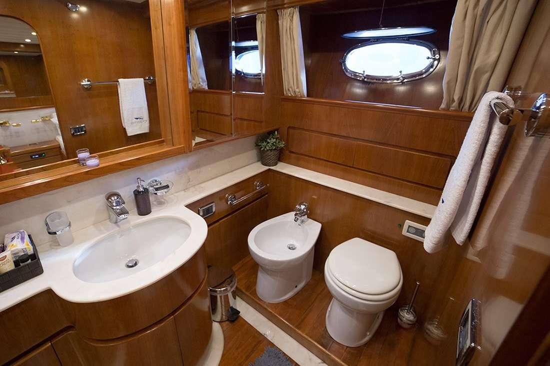 a bathroom with a toilet and a sink aboard ROCK MOON Yacht for Charter