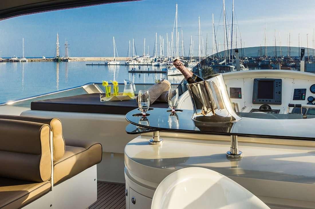 a person pouring a glass of wine on a boat aboard ROCK MOON Yacht for Charter