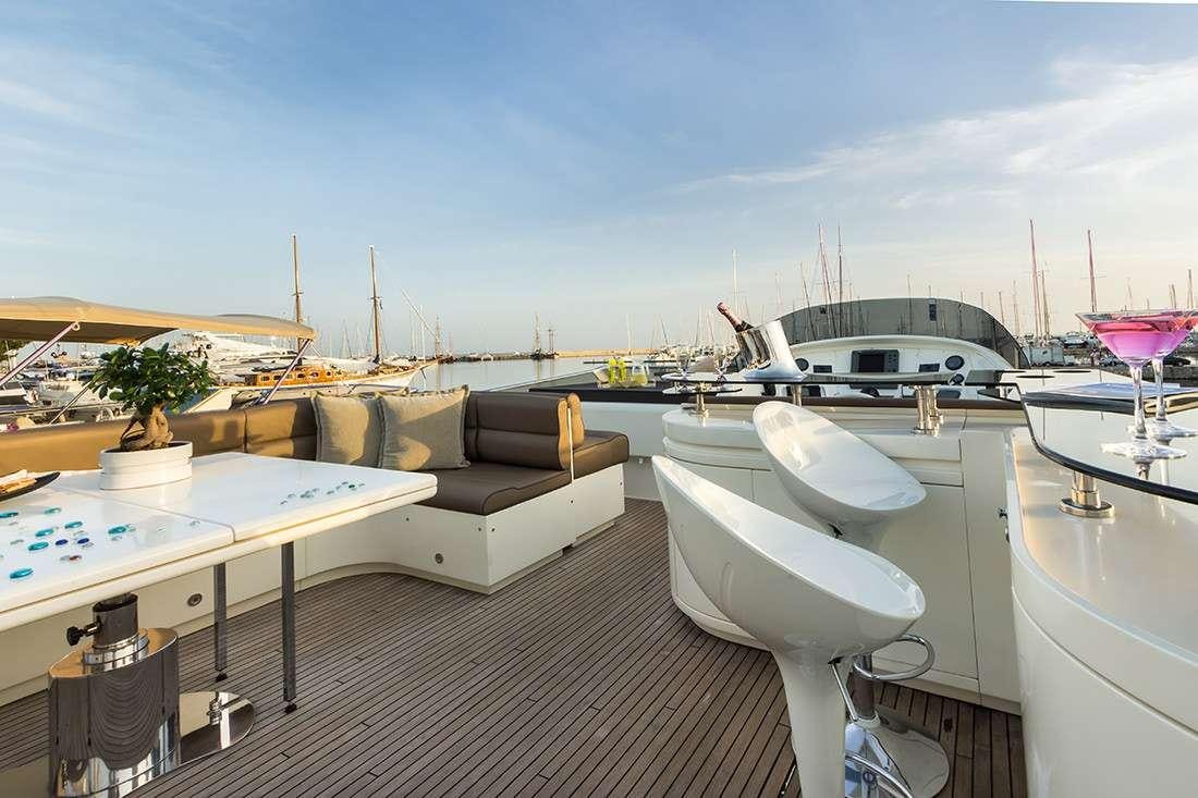 a deck with a table and chairs aboard ROCK MOON Yacht for Charter