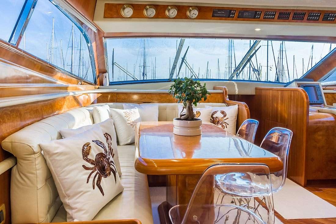 a room with a table and chairs aboard ROCK MOON Yacht for Charter