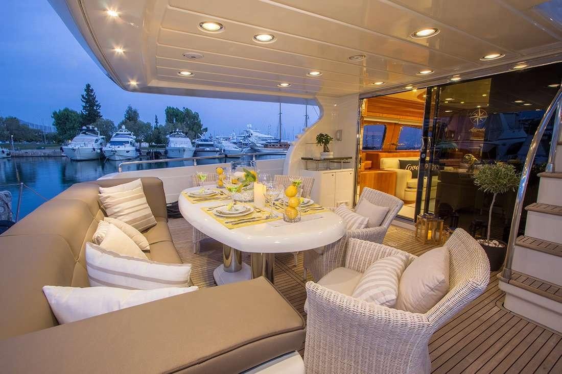 a room with a table chairs and a large window aboard ROCK MOON Yacht for Charter