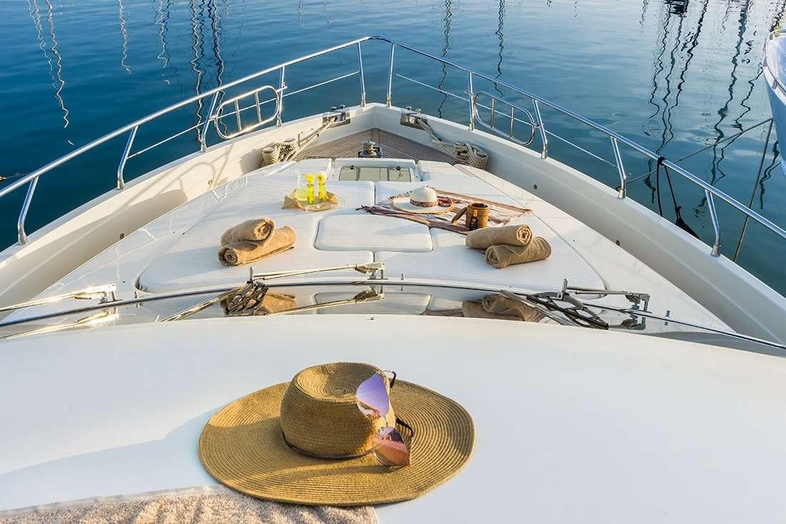 a boat with a hat and sunglasses on it aboard ROCK MOON Yacht for Charter