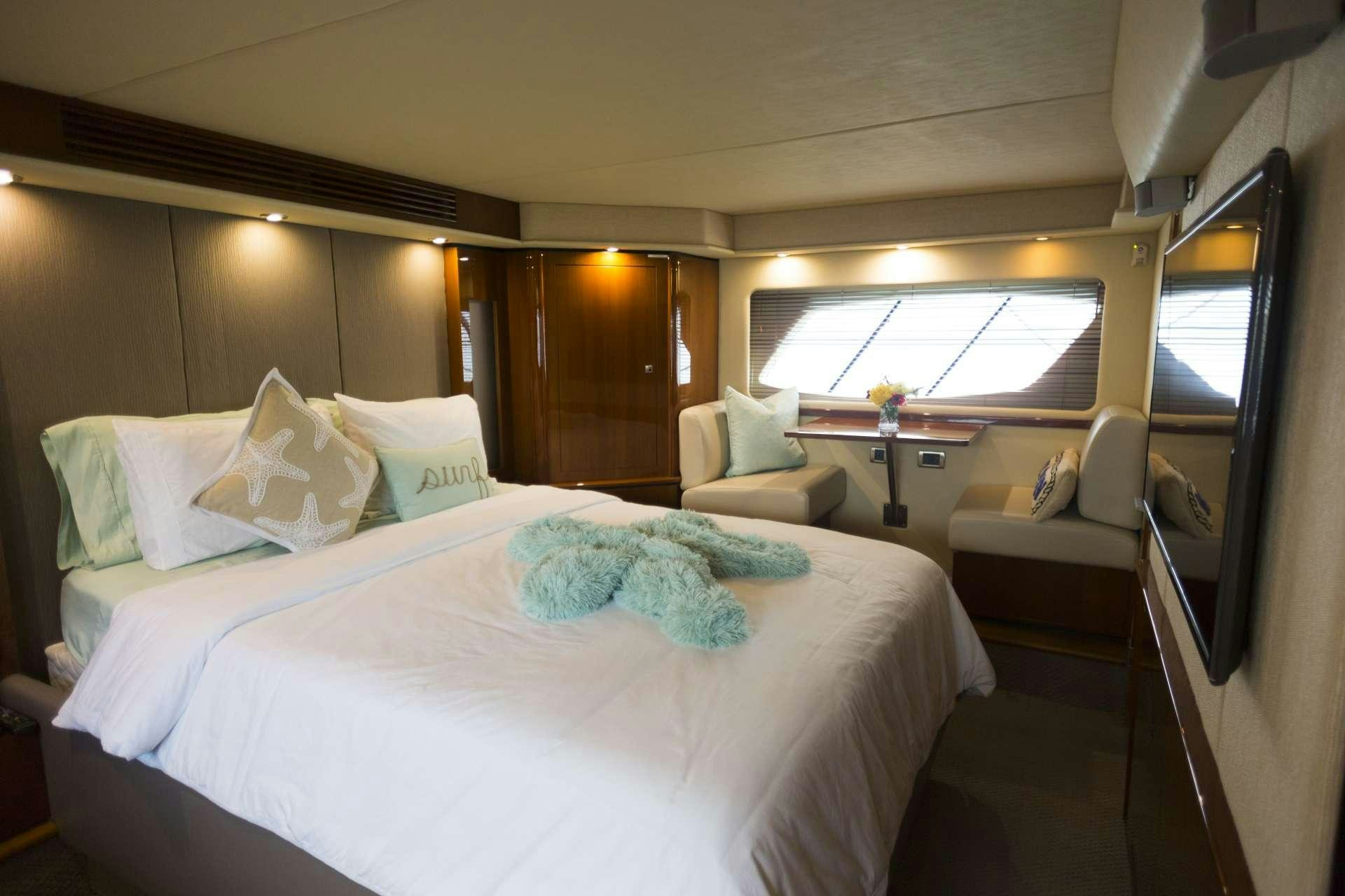 a bed with a white sheet and pillows aboard ANOTHER CHANCE II Yacht for Charter