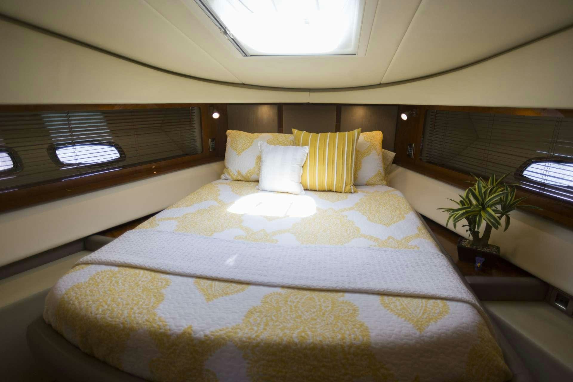 a bed with yellow pillows aboard ANOTHER CHANCE II Yacht for Charter