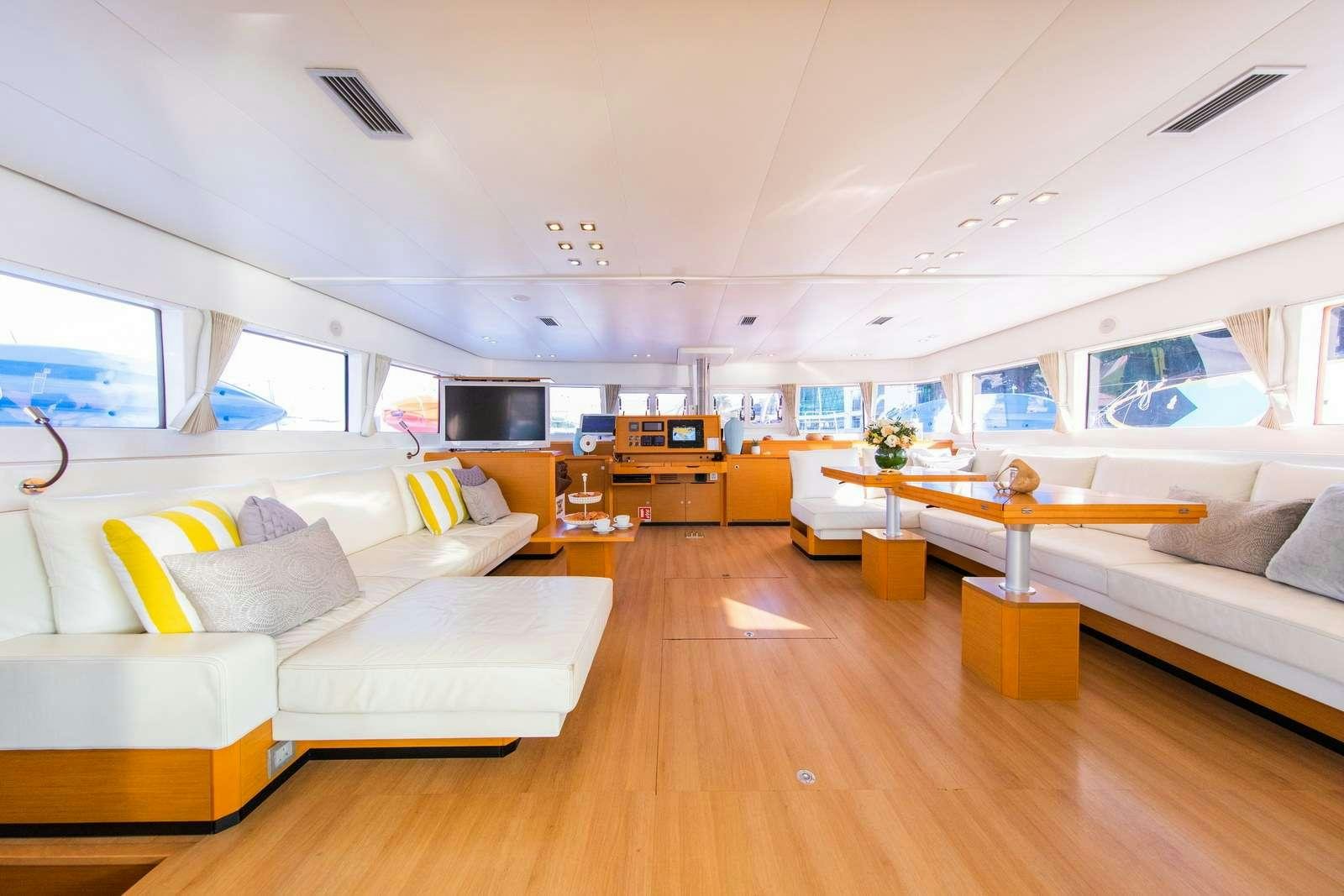 a living room with a couch and a table aboard JYOHANA Yacht for Charter