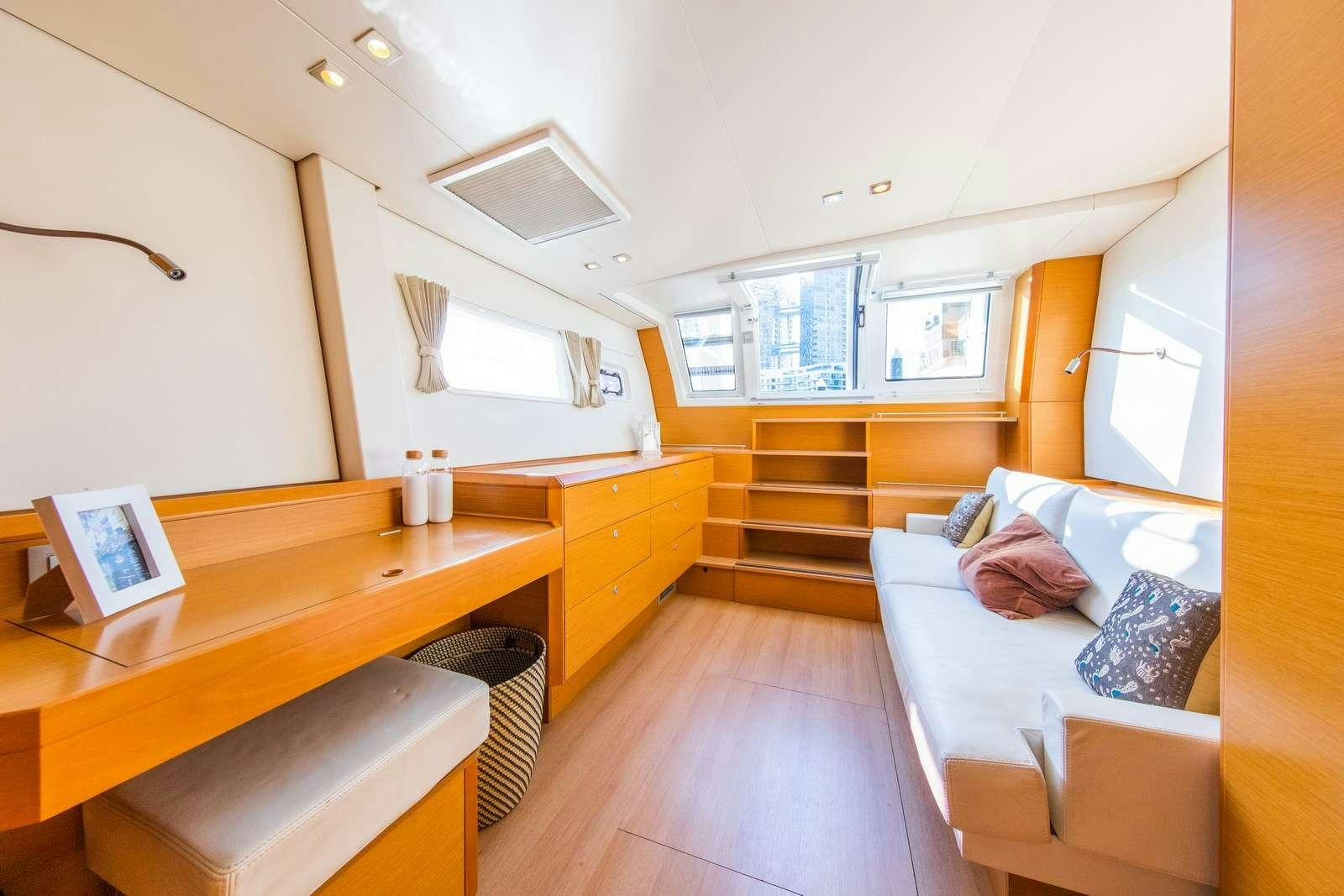 a room with a bed and a desk aboard JYOHANA Yacht for Charter