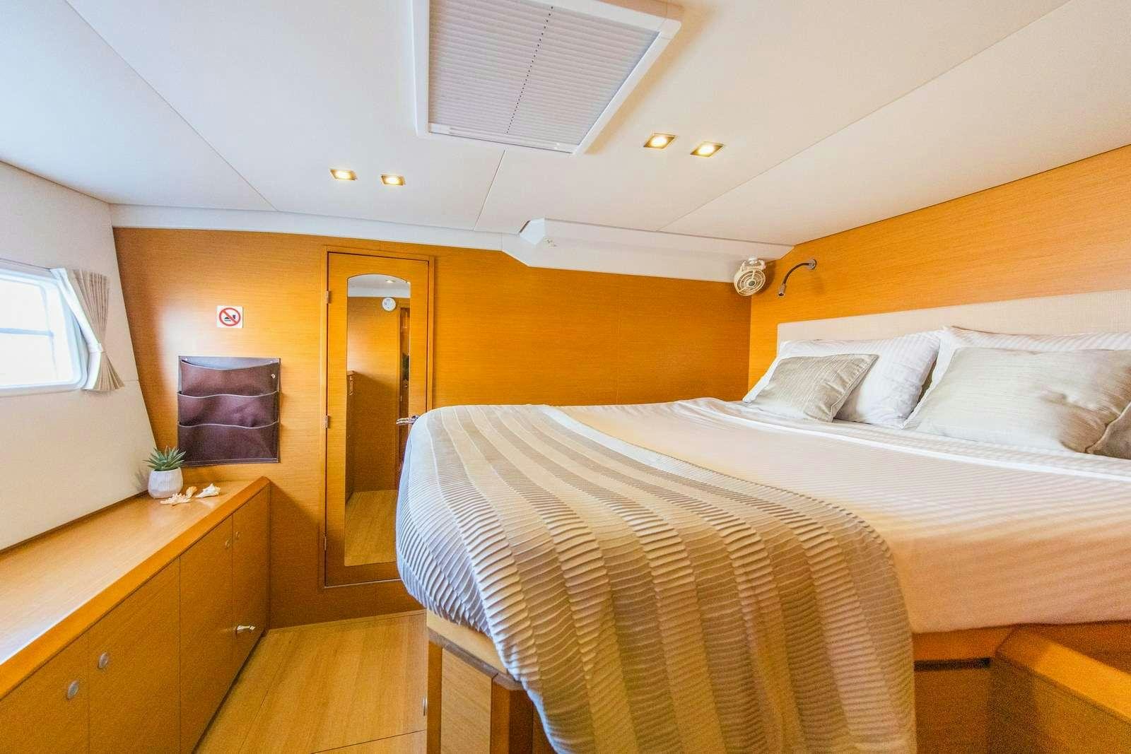 a room with a bed and a desk aboard JYOHANA Yacht for Charter