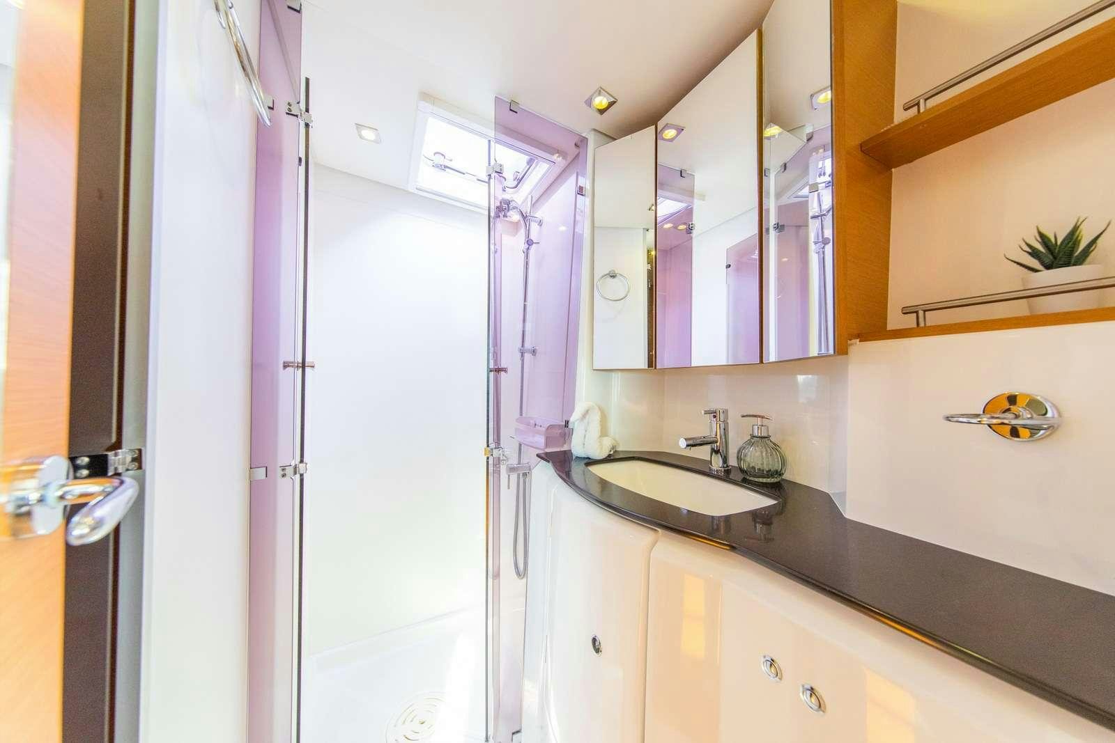 a bathroom with a sink and a mirror aboard JYOHANA Yacht for Charter