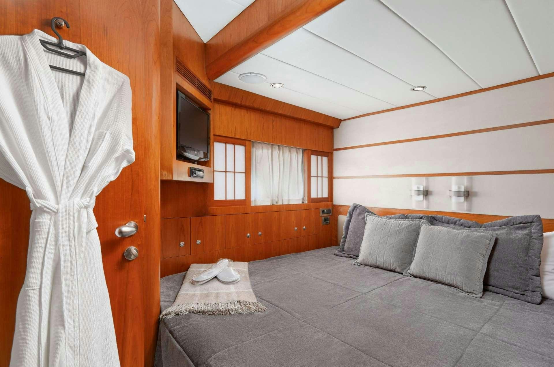 a bed with a white sheet aboard ANNABEL II Yacht for Charter