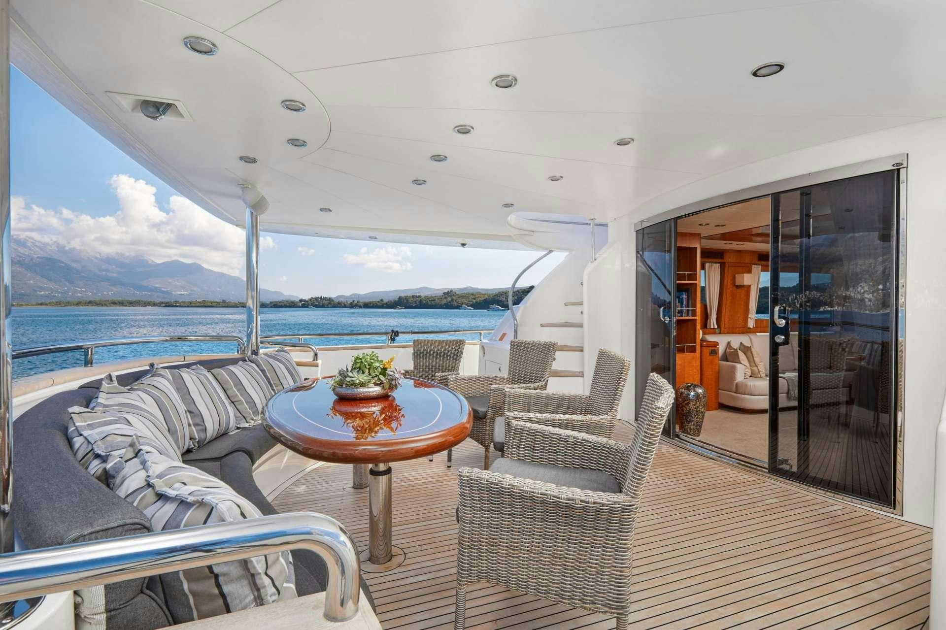 a boat with a table and chairs on the deck aboard ANNABEL II Yacht for Charter