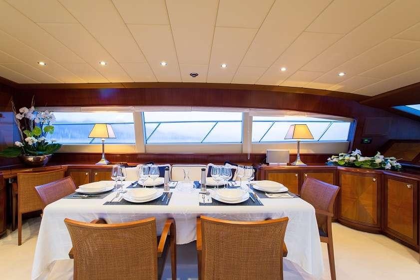 a dining room with a table set aboard 7 KNOTS Yacht for Charter