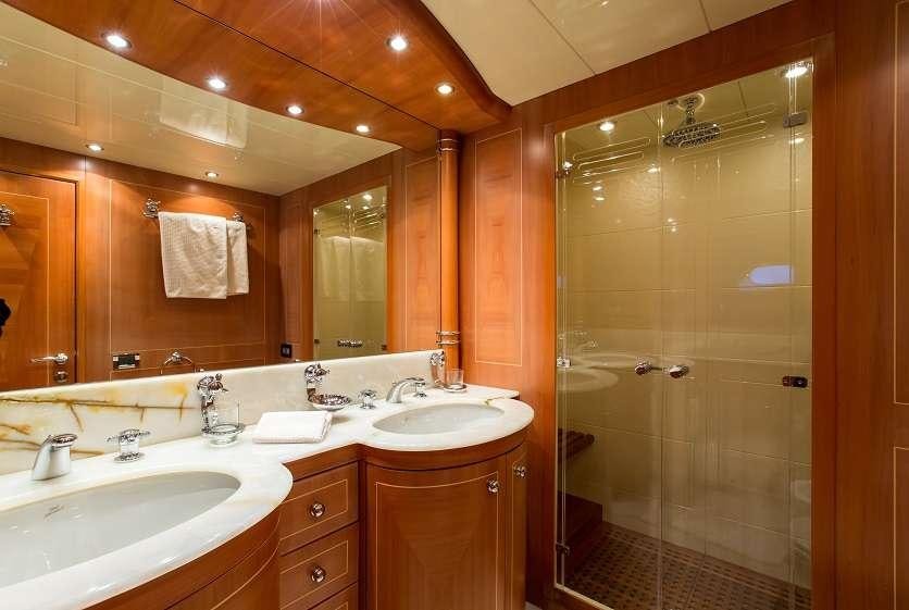 a bathroom with a shower and sinks aboard 7 KNOTS Yacht for Charter