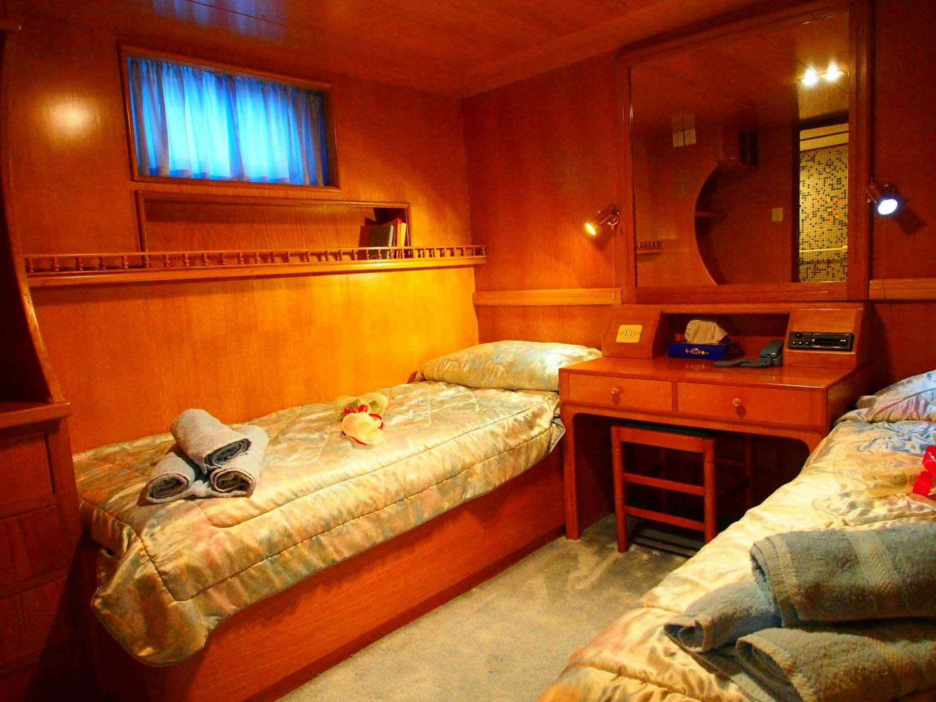 a bedroom with two beds aboard K Yacht for Charter