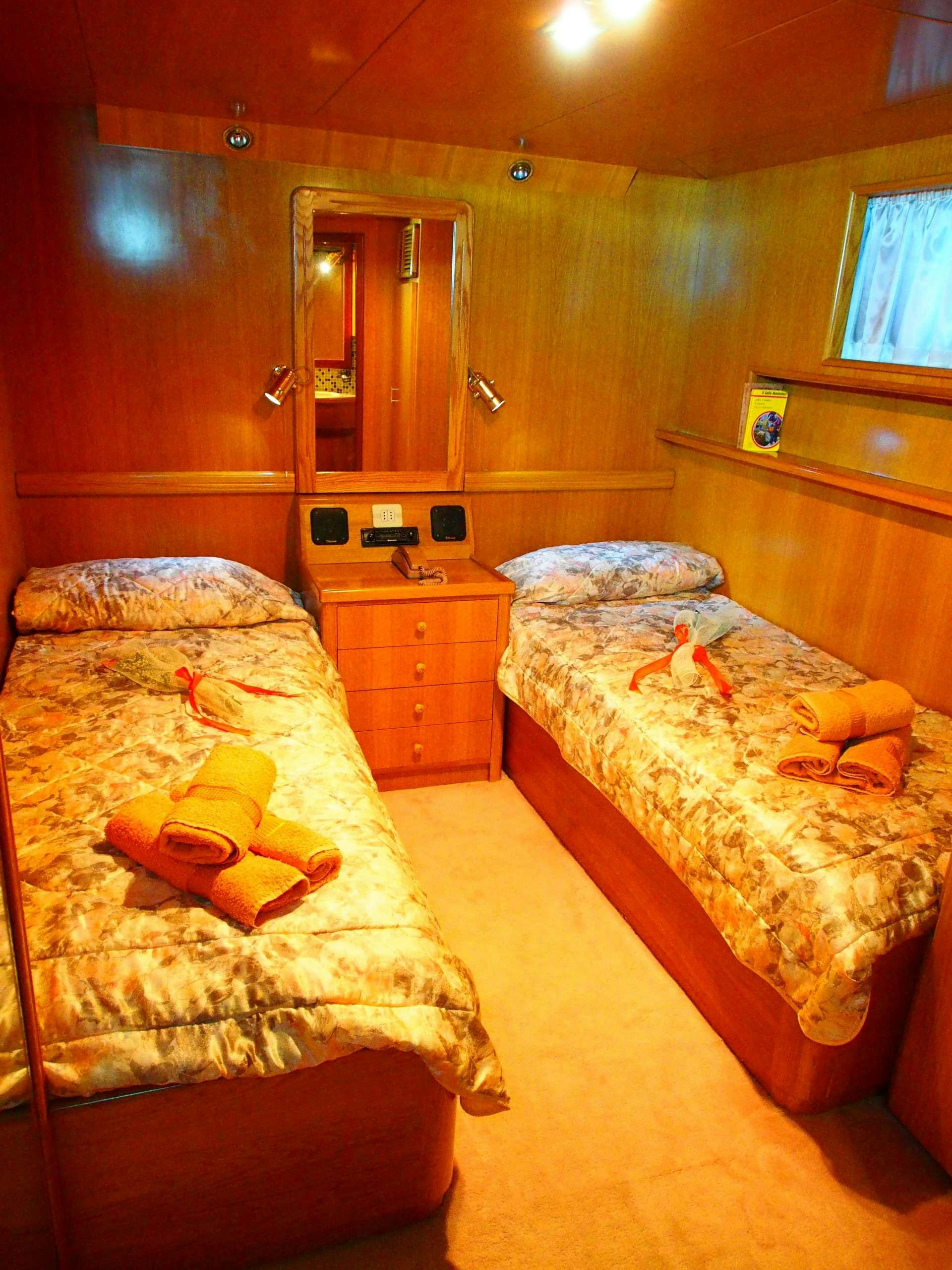 a bedroom with two beds aboard K Yacht for Charter