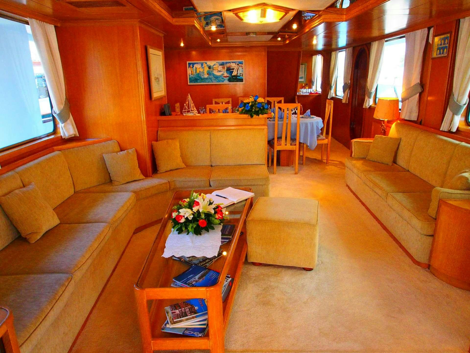 a living room with a couch and a coffee table aboard K Yacht for Charter