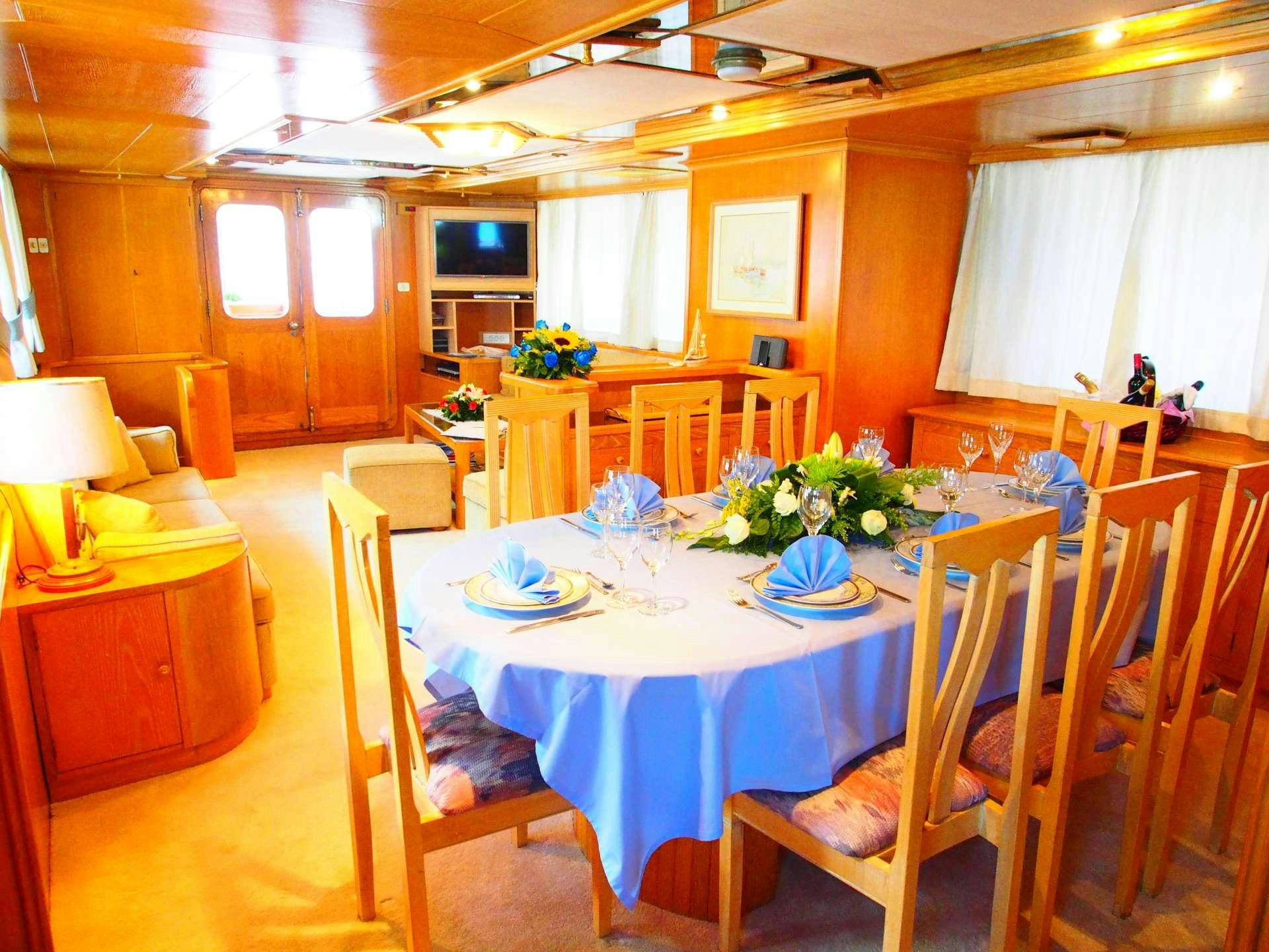 a dining room with tables and chairs aboard K Yacht for Charter