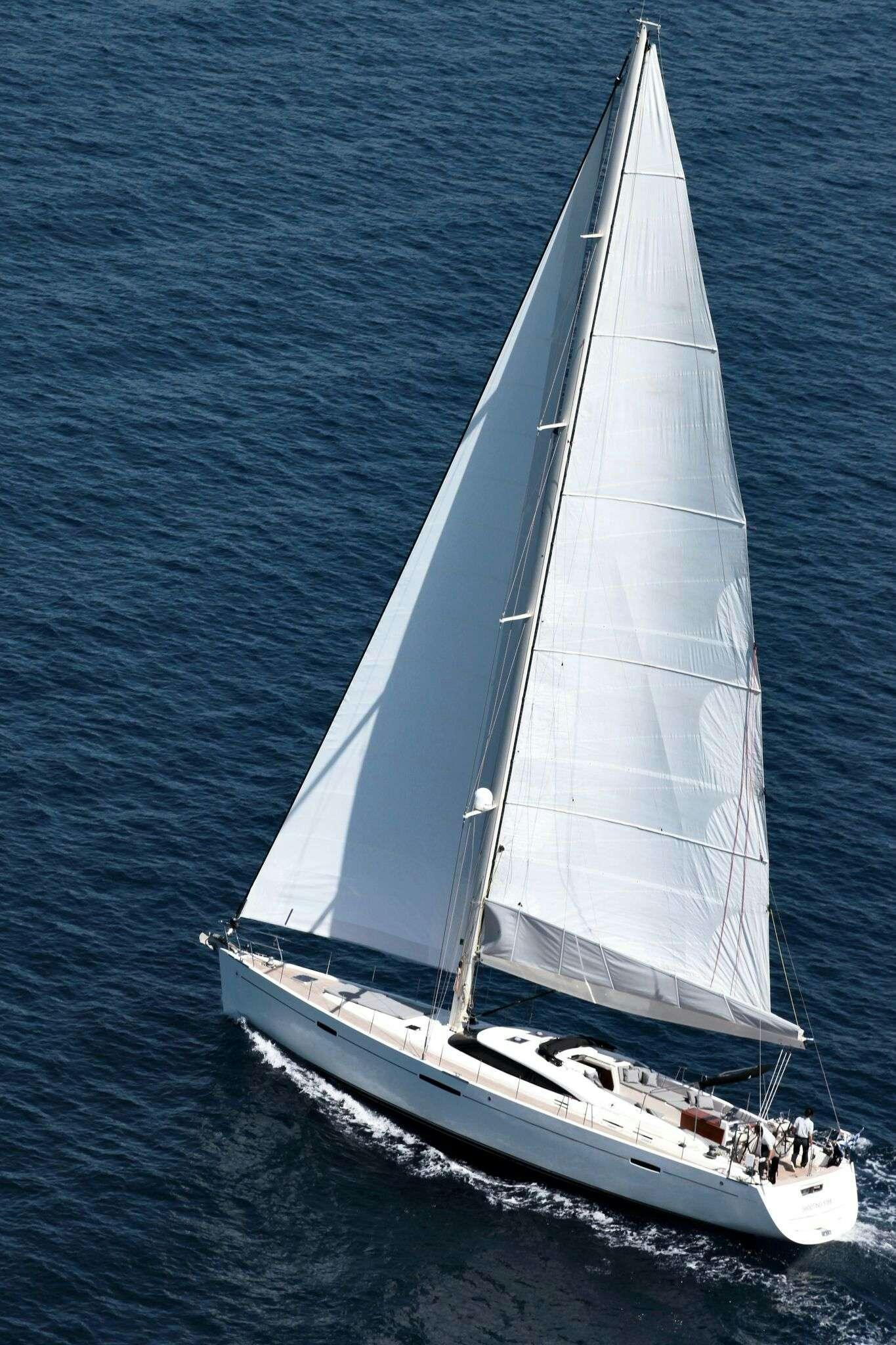 a white sailboat on the water aboard SHOOTING STAR Yacht for Charter