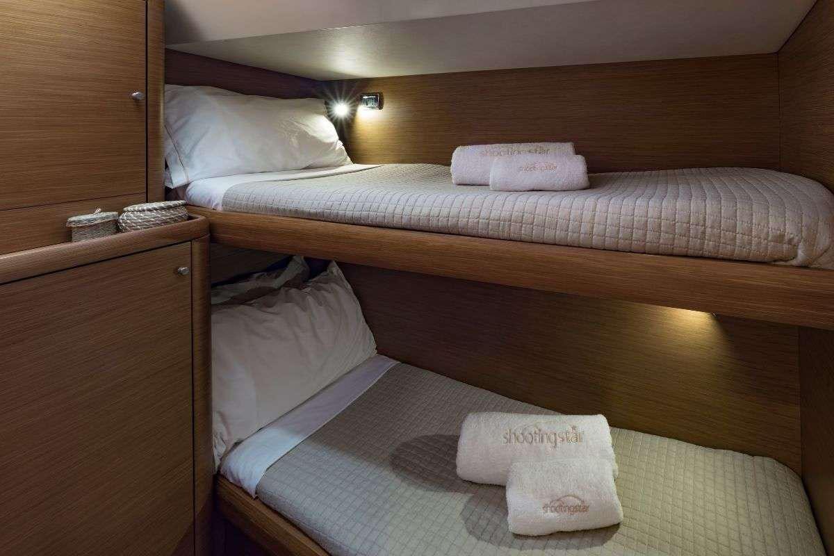 a hotel room with two beds aboard SHOOTING STAR Yacht for Charter