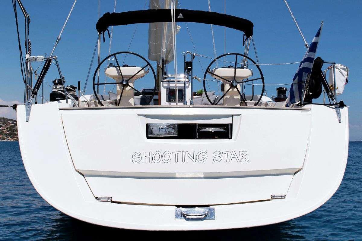 a white boat with a steering wheel aboard SHOOTING STAR Yacht for Charter