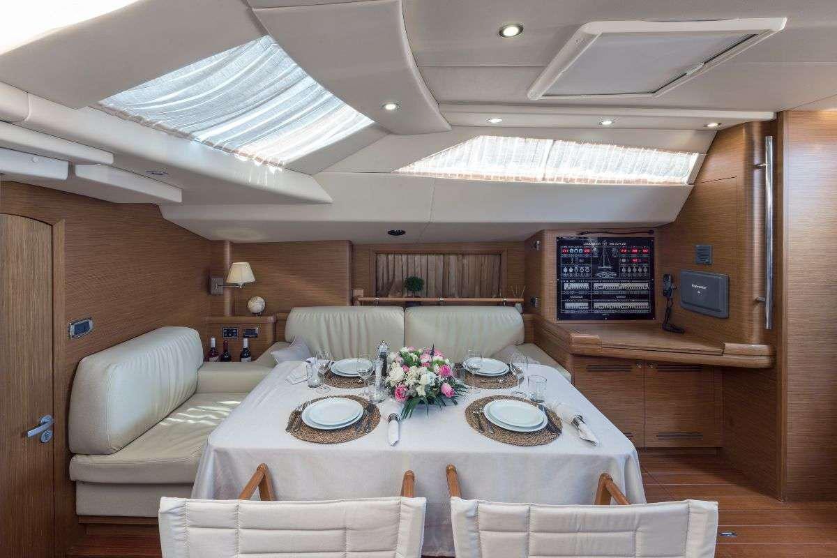 a large room with a table and chairs aboard SHOOTING STAR Yacht for Charter