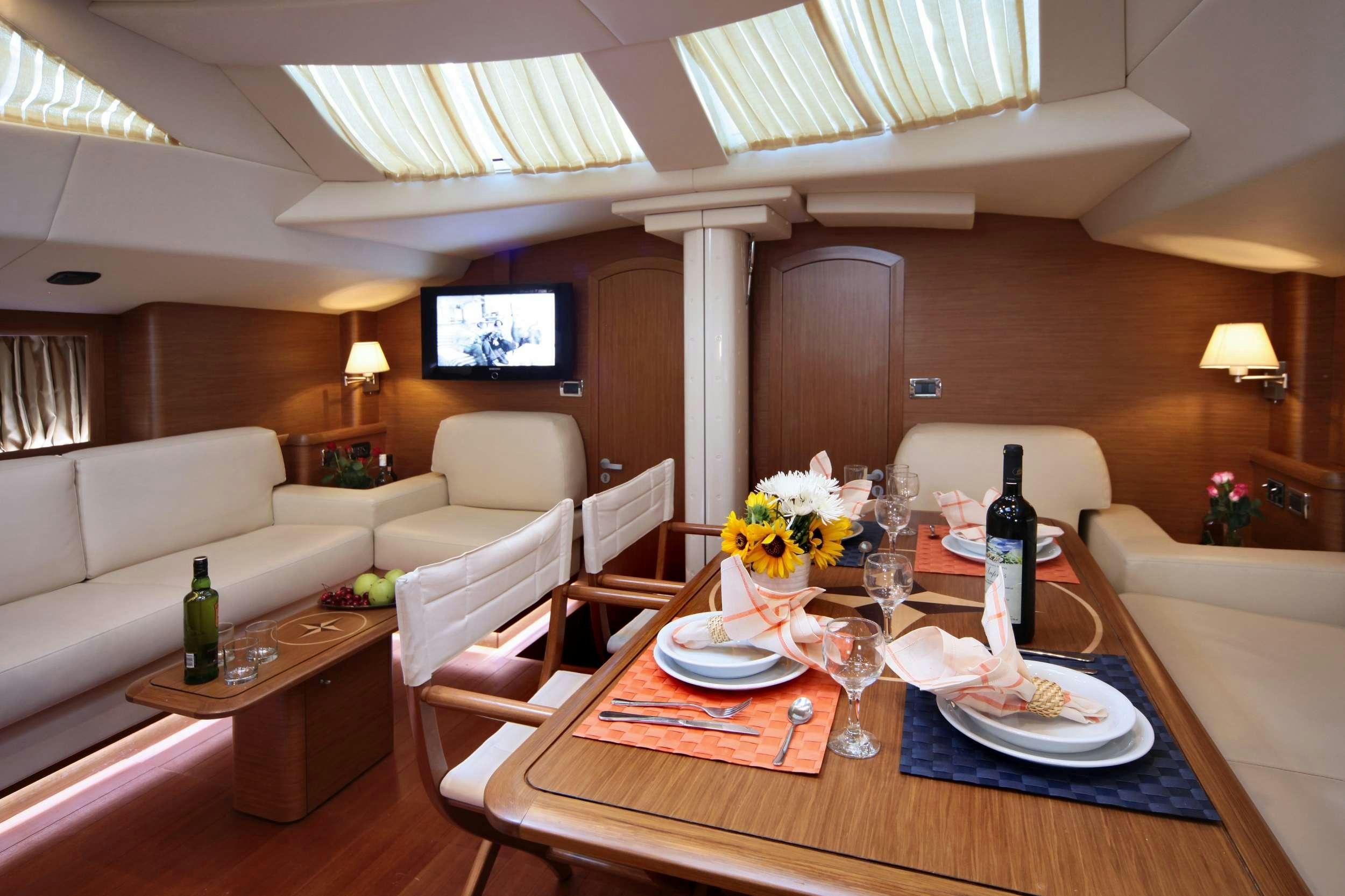 a living room with a table and chairs aboard SHOOTING STAR Yacht for Charter