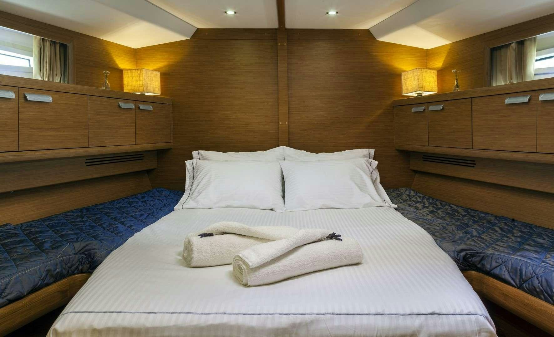 a bed with white sheets aboard SHOOTING STAR Yacht for Charter