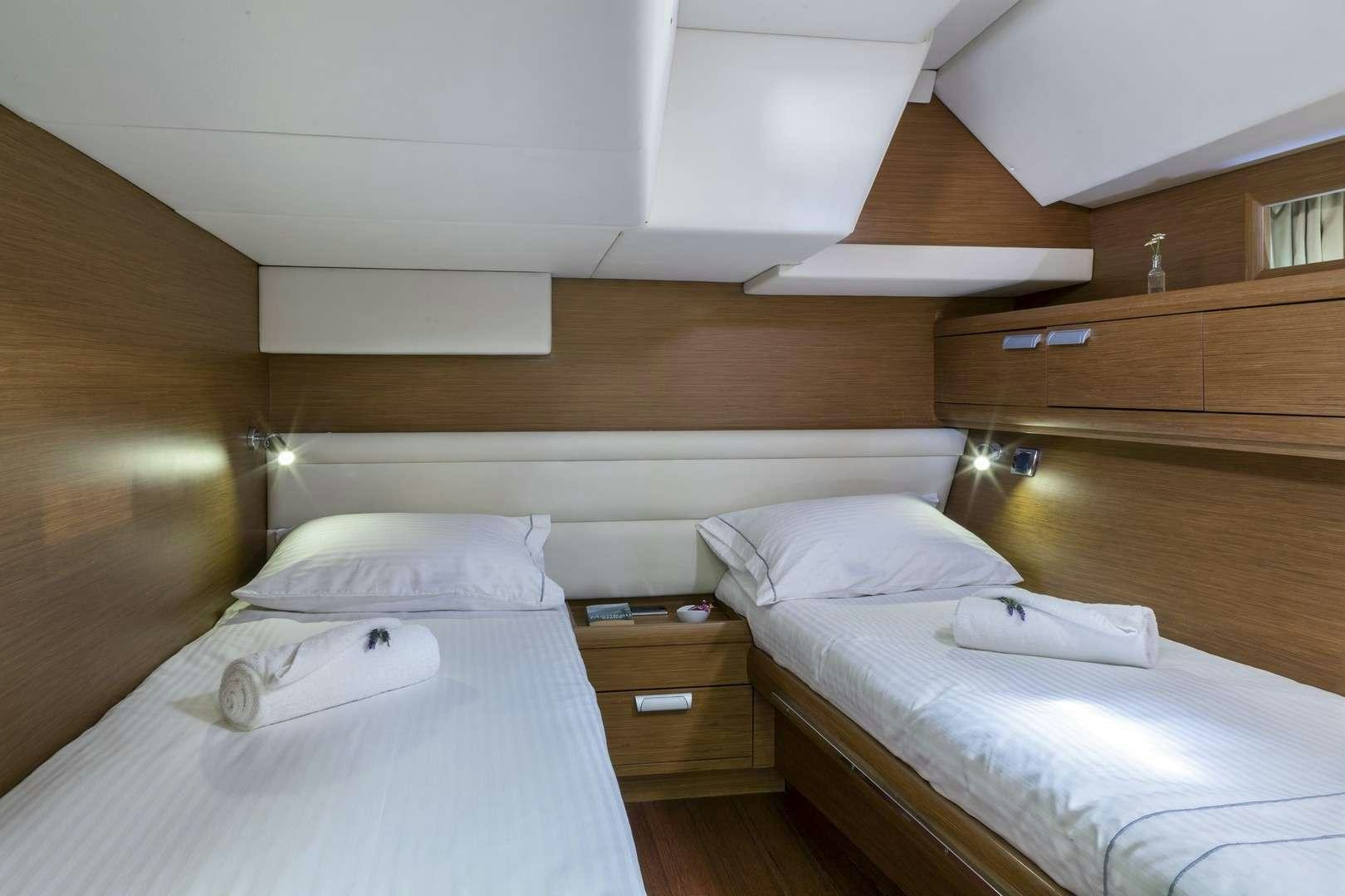 a room with two beds aboard SHOOTING STAR Yacht for Charter