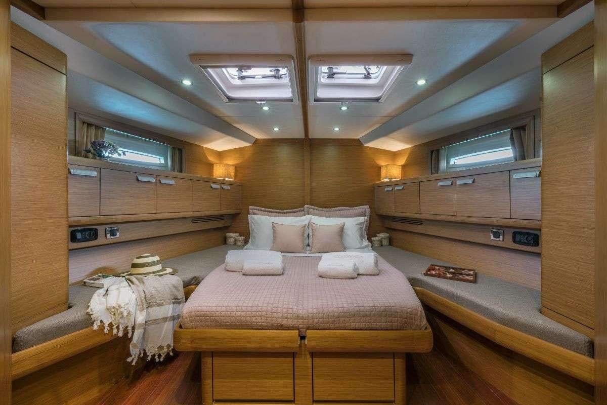 a room with beds and a large mirror aboard SHOOTING STAR Yacht for Charter