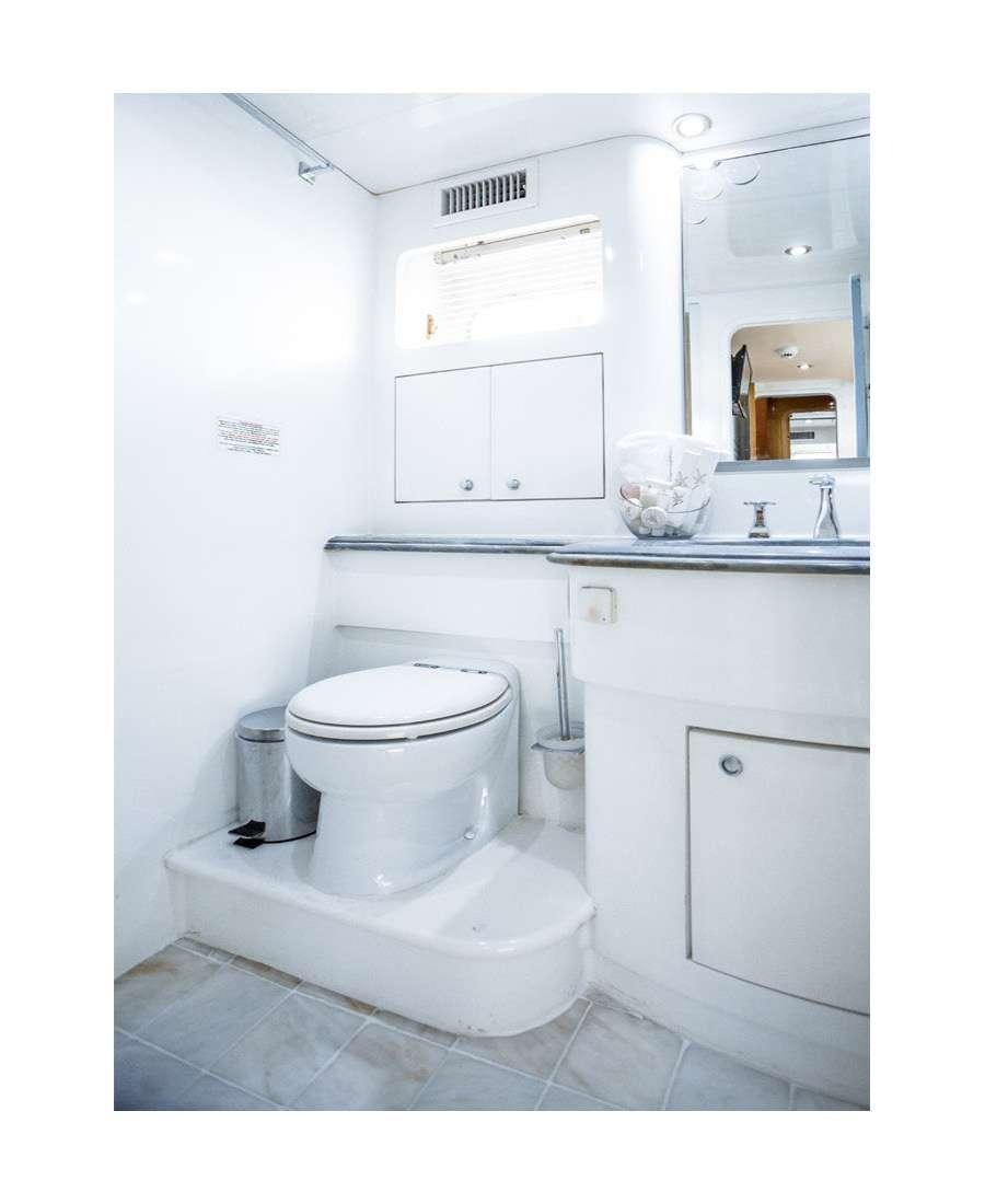 a bathroom with a toilet and a sink aboard DREAM Yacht for Charter