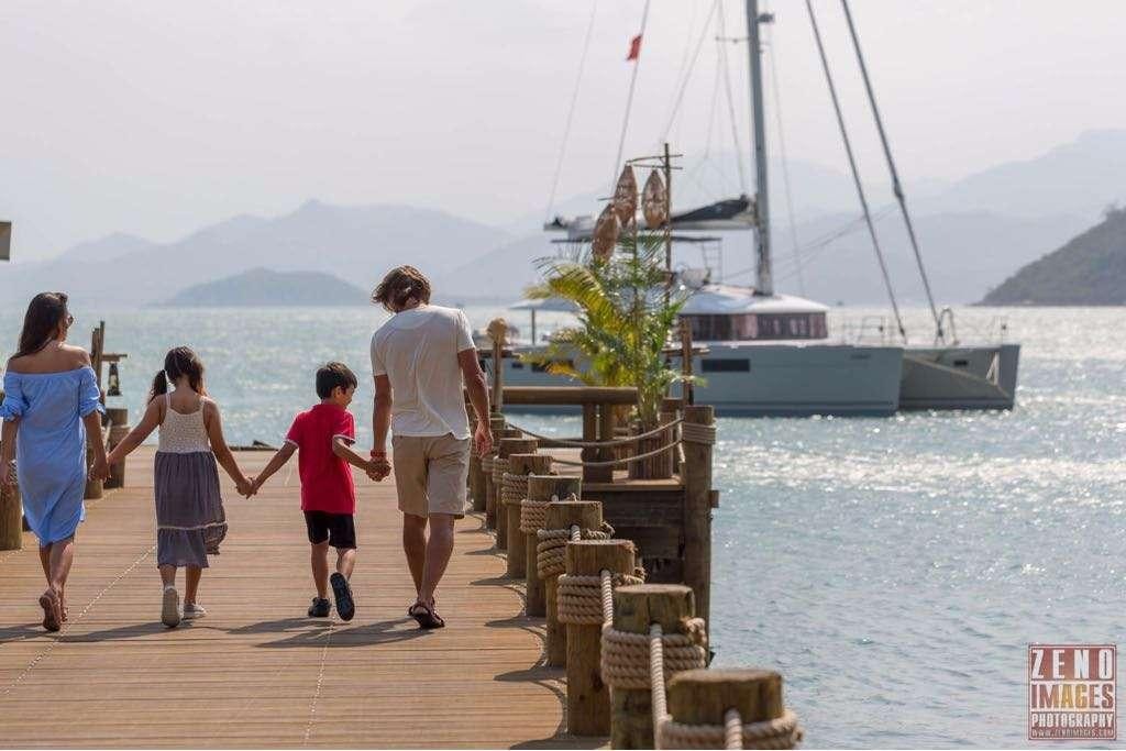 a group of people walking on a dock towards a boat aboard ELLEN SOPHIA Yacht for Charter