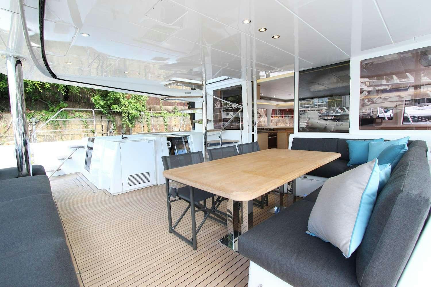 a room with a table and couch aboard ELLEN SOPHIA Yacht for Charter