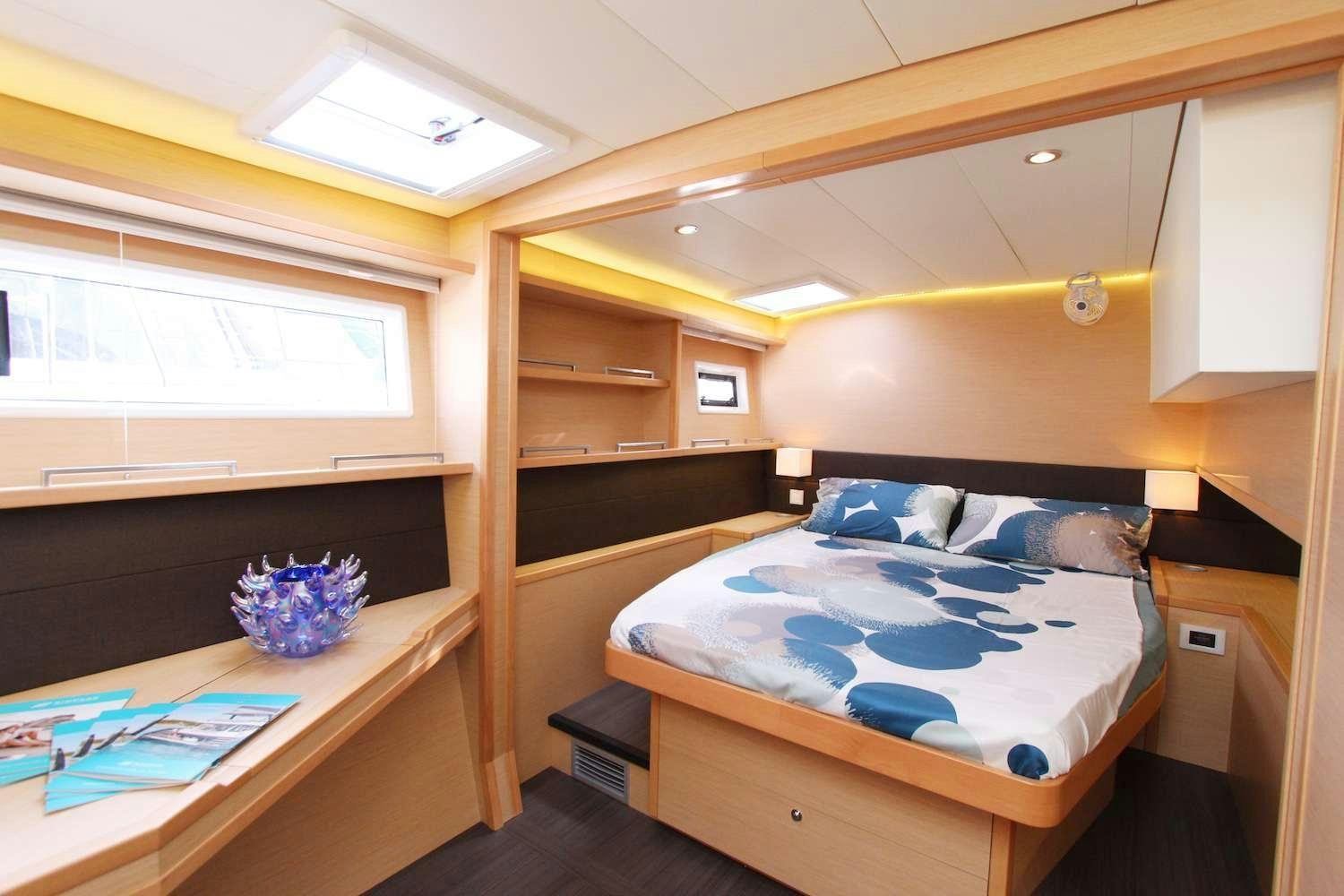 a room with a bed and a desk aboard ELLEN SOPHIA Yacht for Charter