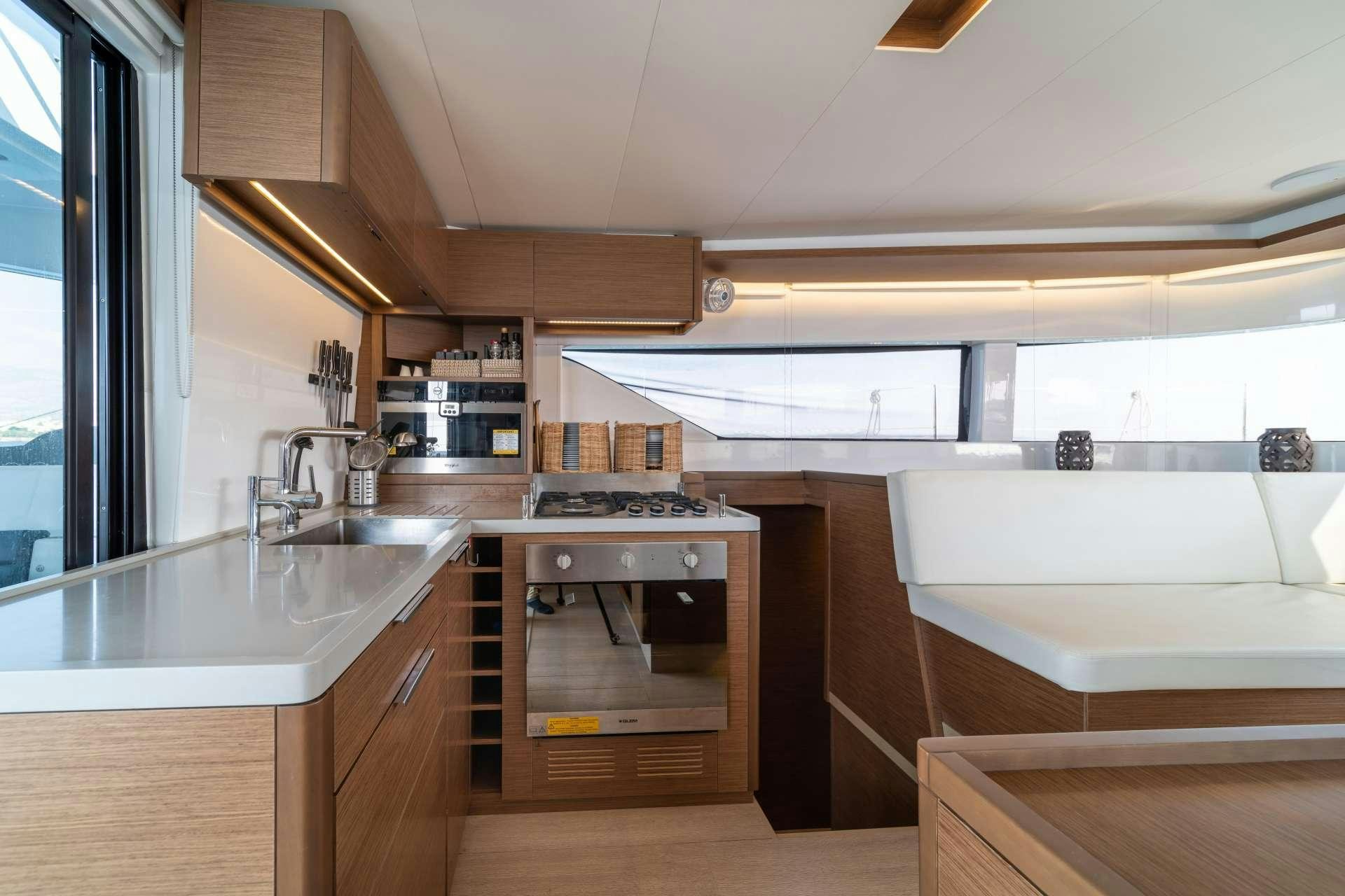 a kitchen with a stove and sink aboard KaLiMar Yacht for Charter