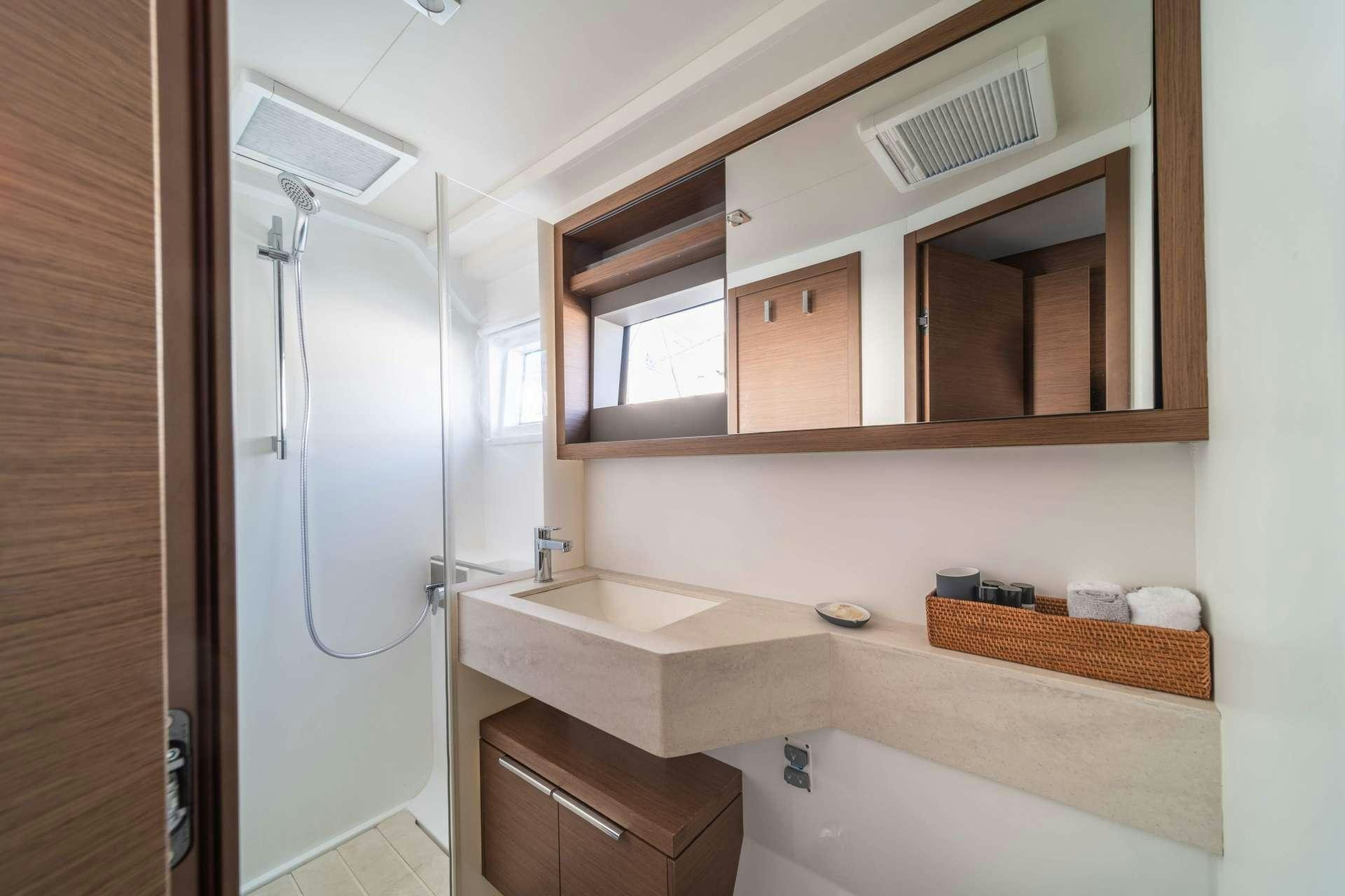 a bathroom with a shower unit and a sink aboard KaLiMar Yacht for Charter