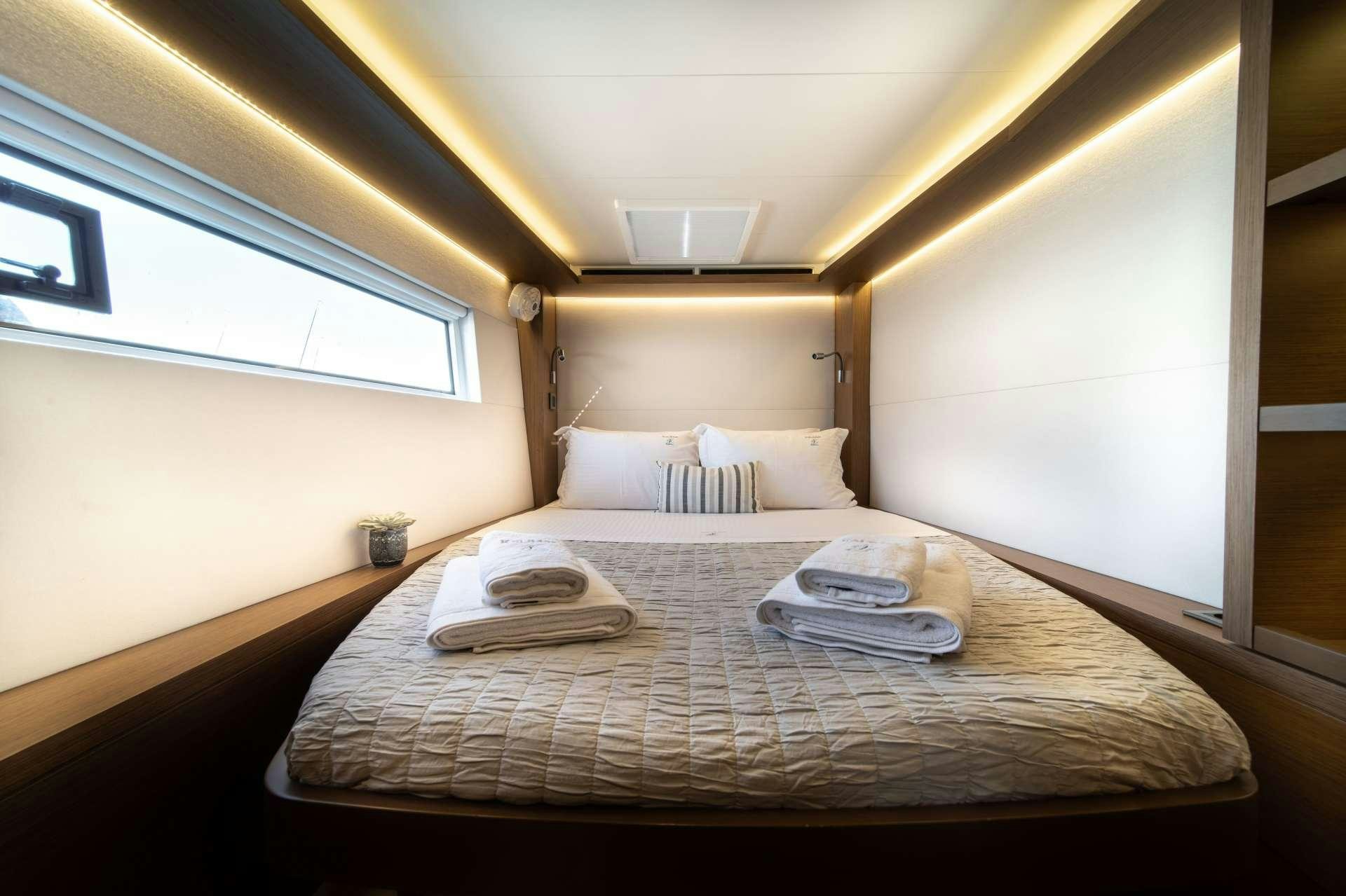 a bed with a tray on it aboard KaLiMar Yacht for Charter
