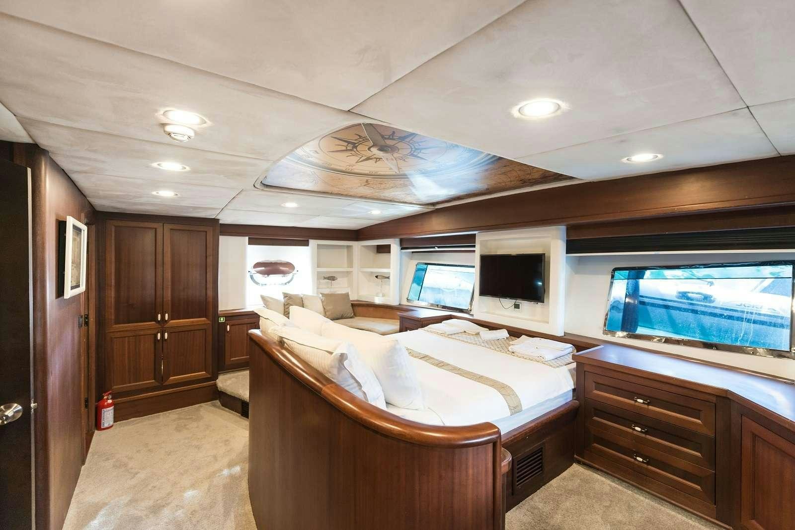 a bedroom with a large bed aboard VIRTUOSO Yacht for Charter