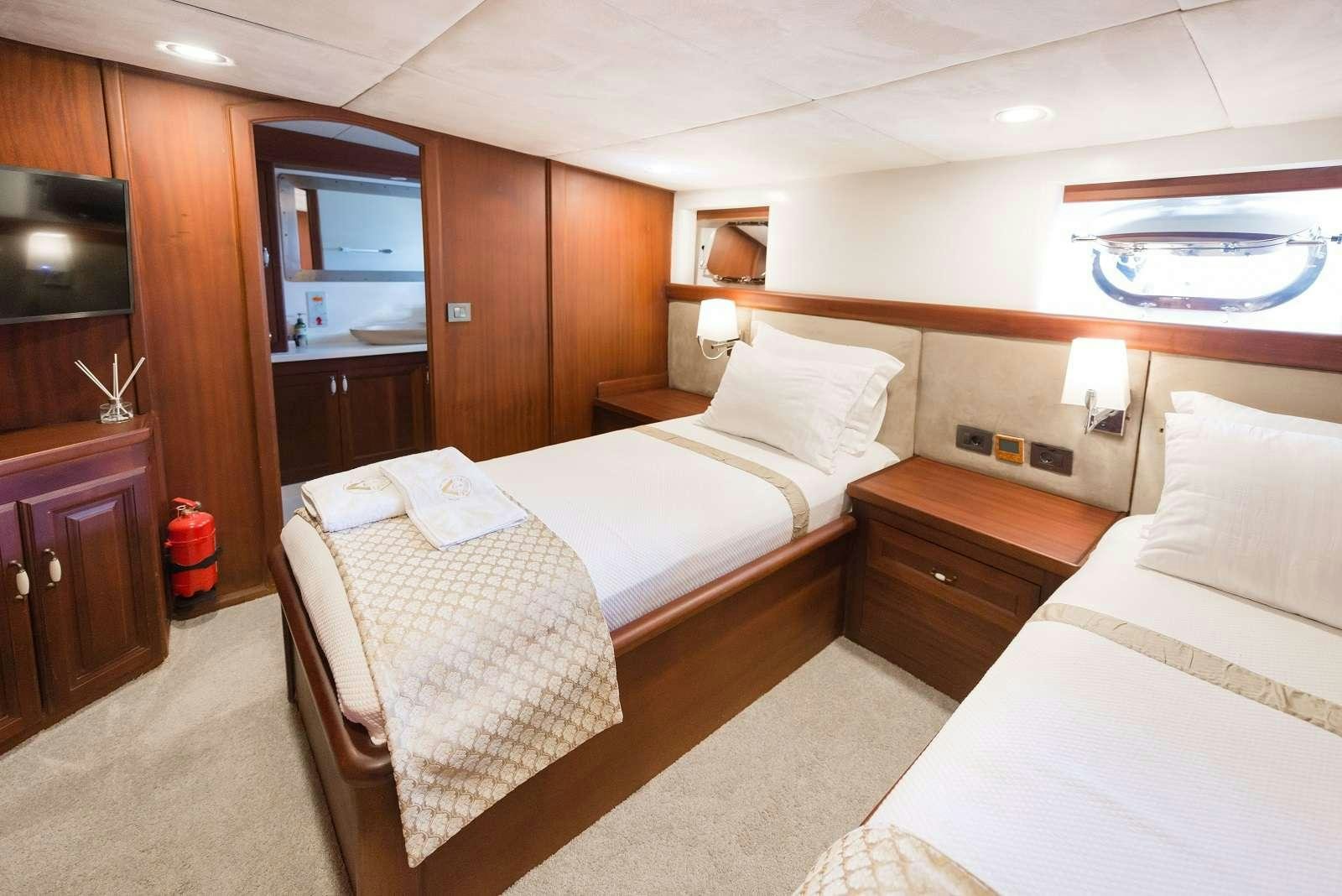 a hotel room with two beds aboard VIRTUOSO Yacht for Charter